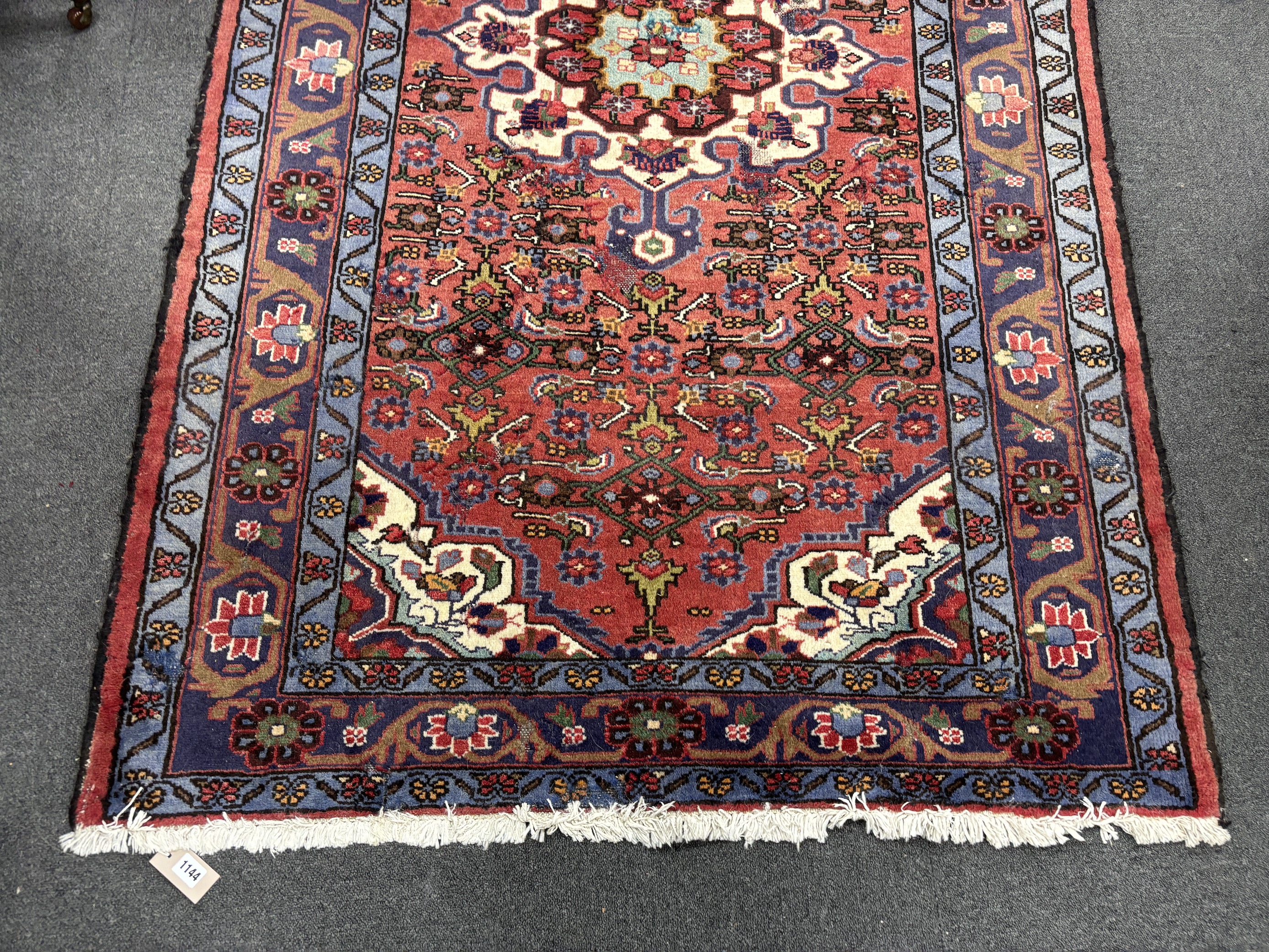 A Caucasian red ground rug, 206 x 130cm